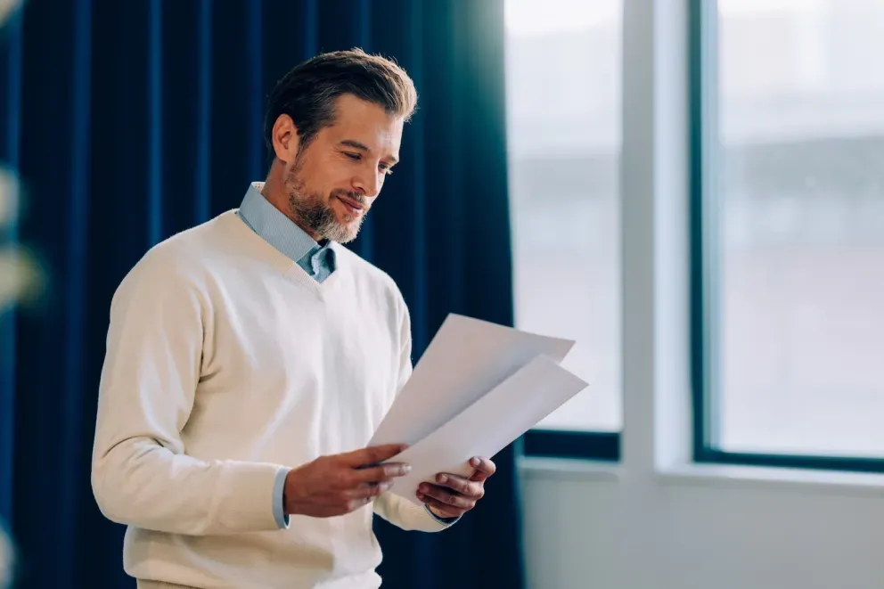 business man looking at paperwork business man looking at paperwork