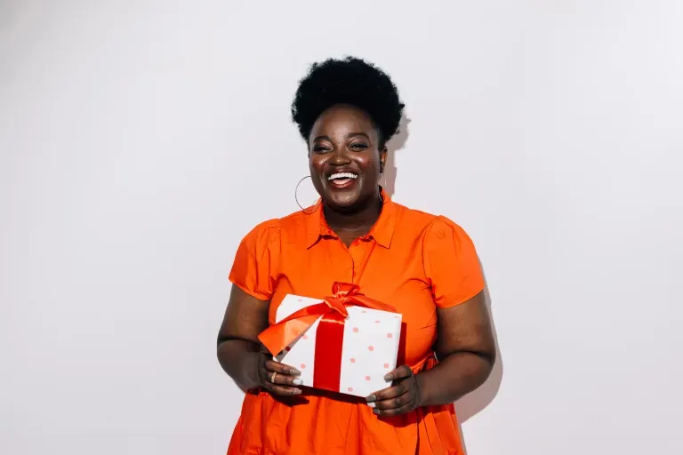 Woman holding holiday gift Woman holding holiday gift