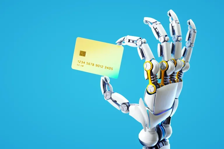 Robot holding credit card Robot holding credit card