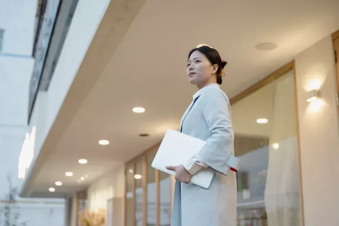 Woman holding a laptop Woman holding a laptop