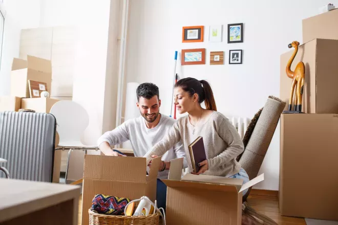 Couple unpacking boxes in new home Couple unpacking boxes in new home