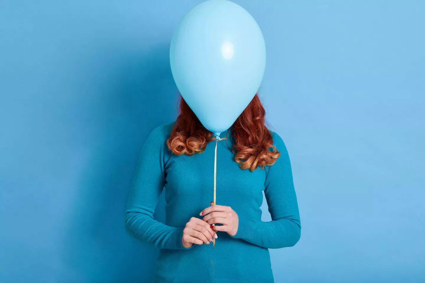 Person hiding behind a balloon Person hiding behind a balloon