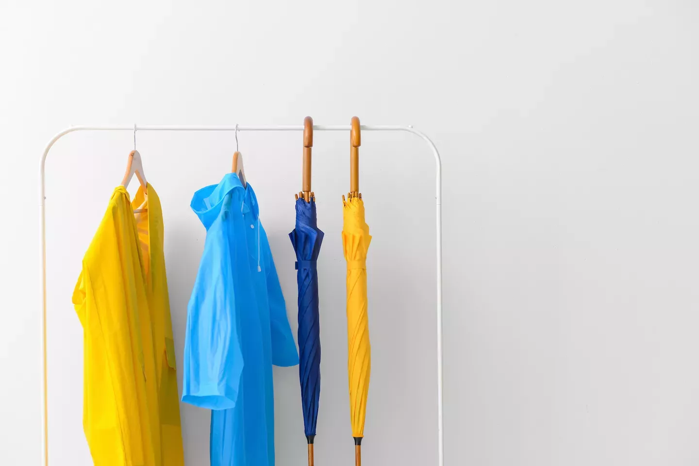 Rack with raincoats and umbrellas Rack with raincoats and umbrellas