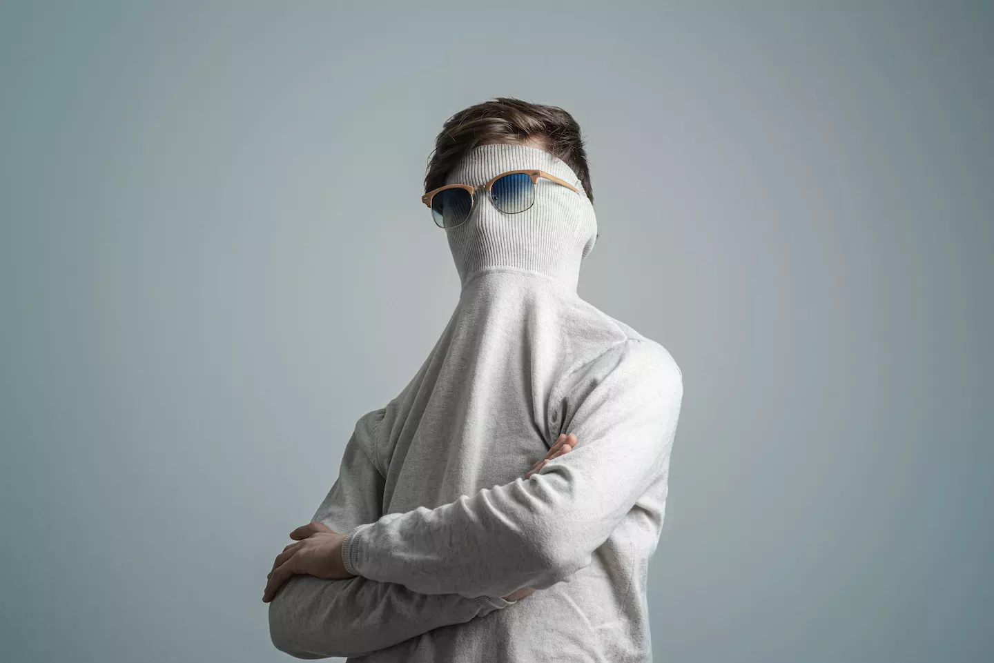Man with sweater and sunglasses over his face Man with sweater and sunglasses over his face