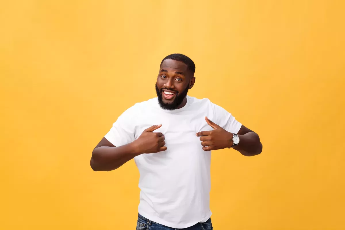 man standing in front of orange background man standing in front of orange background