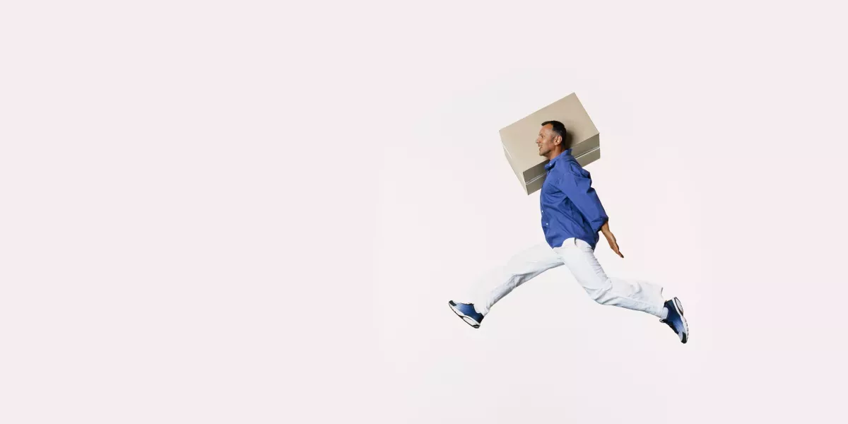 Man jumping with a box Man jumping with a box