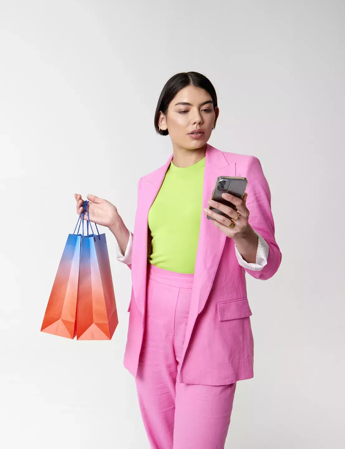 Woman shopping while looking at phone Woman shopping while looking at phone