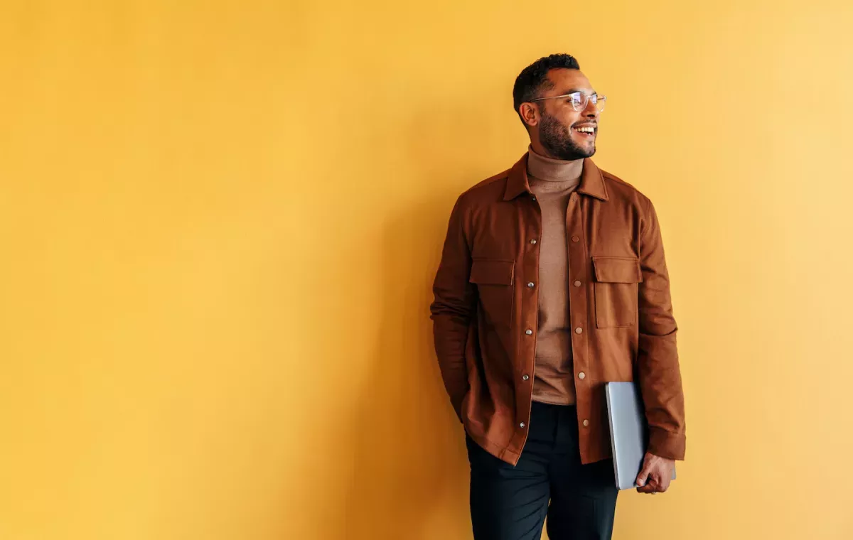 smiling man holding laptop smiling man holding laptop