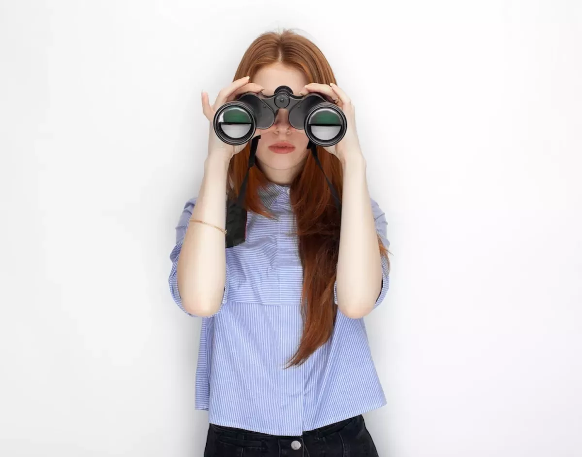 woman looking through binoculars woman looking through binoculars