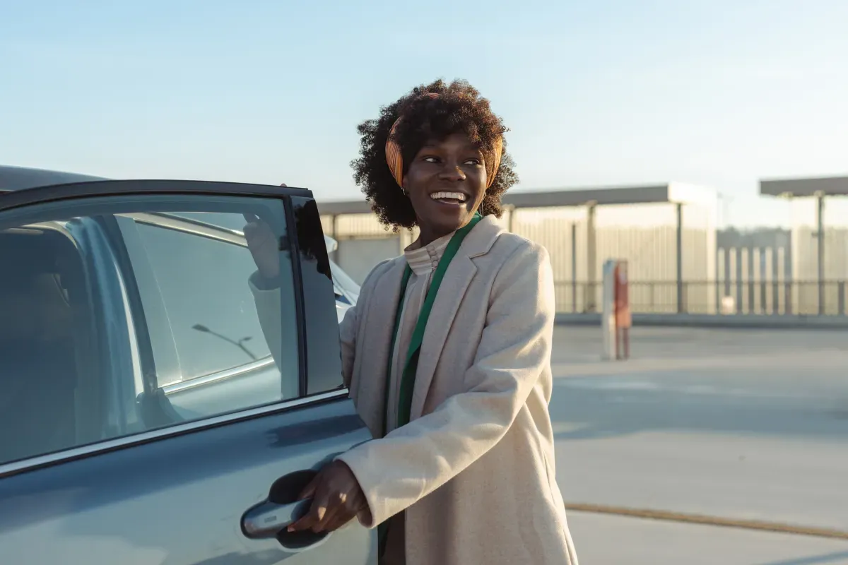 Woman opening car door Woman opening car door