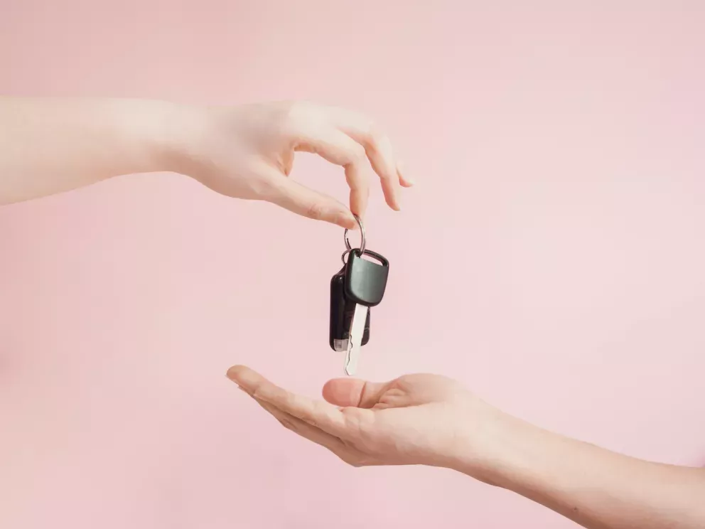 Person giving another person keys Person giving another person keys