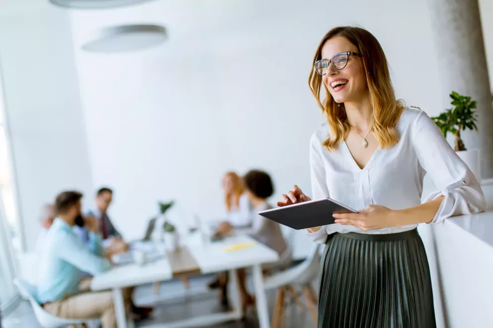 Woman working in an office and smiling Woman working in an office and smiling