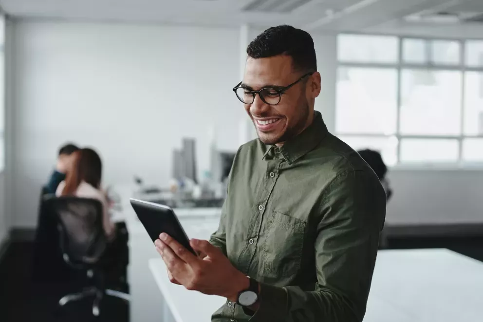 happy man working on tablet in office happy man working on tablet in office
