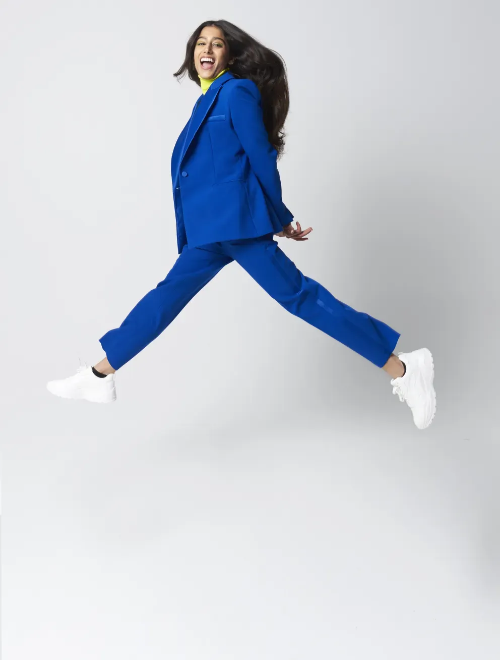 woman in business suit leaping woman in business suit leaping