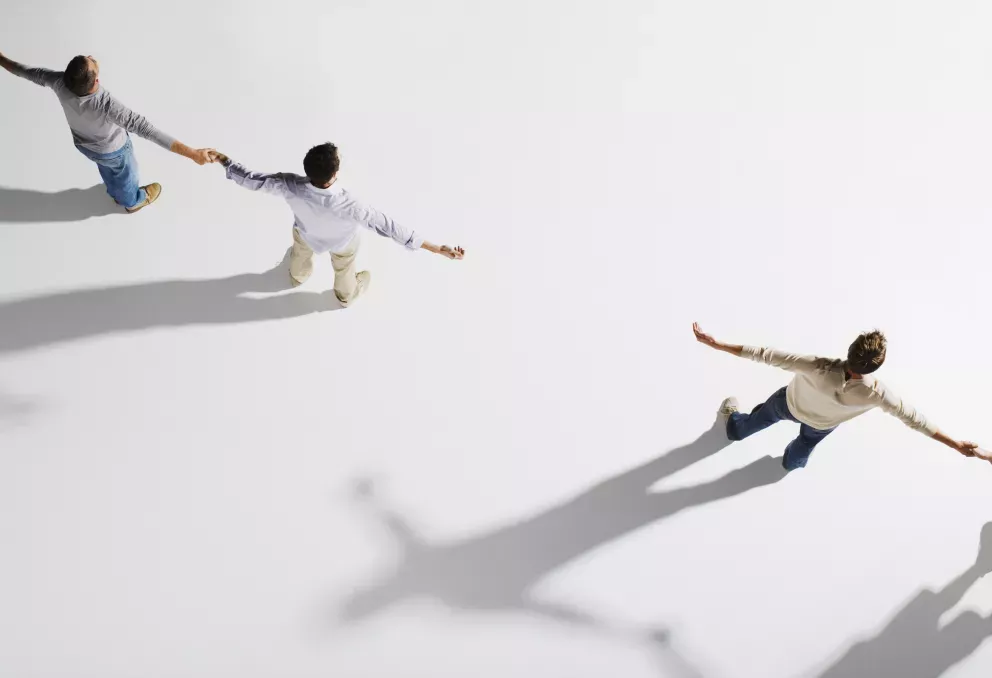 aerial view of people holding hands in a line aerial view of people holding hands in a line