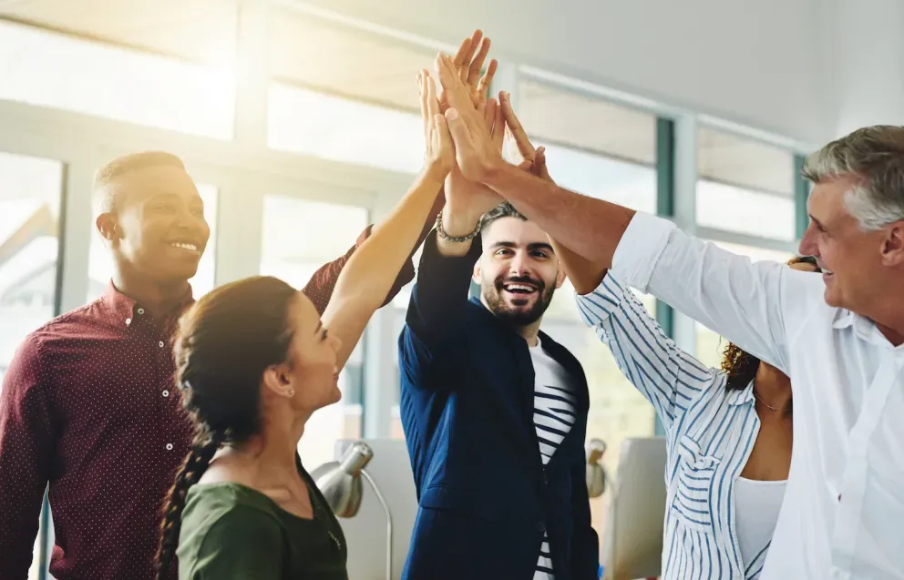 coworkers celebrating achievement with high fives coworkers celebrating achievement with high fives