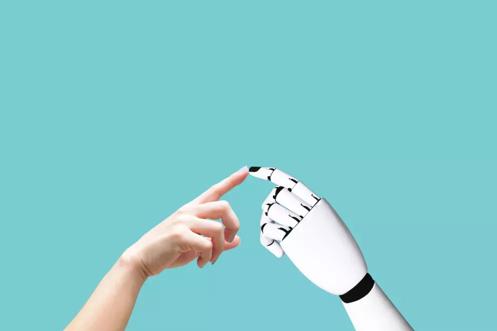 Person and robot touching fingers Person and robot touching fingers