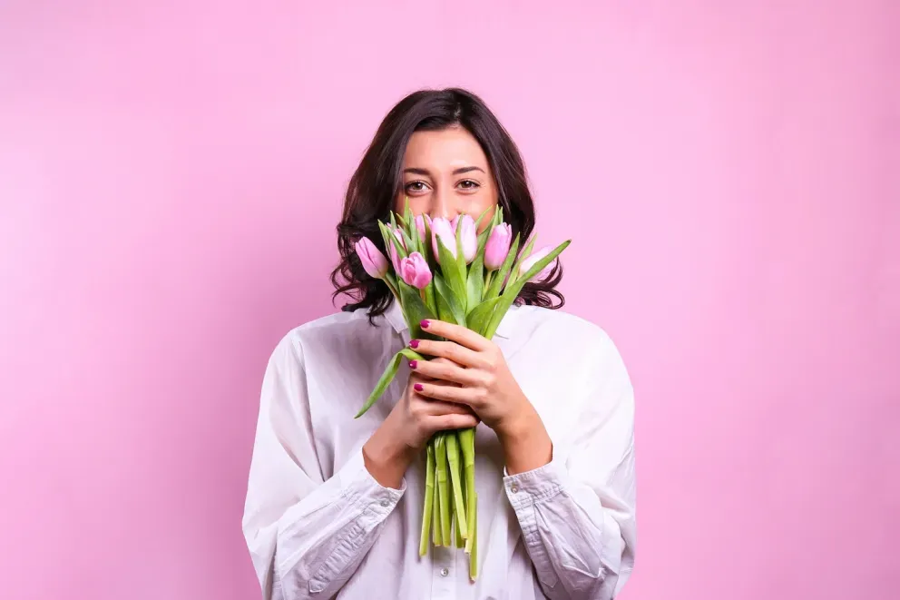person peeking out of a bouquet of flowers person peeking out of a bouquet of flowers