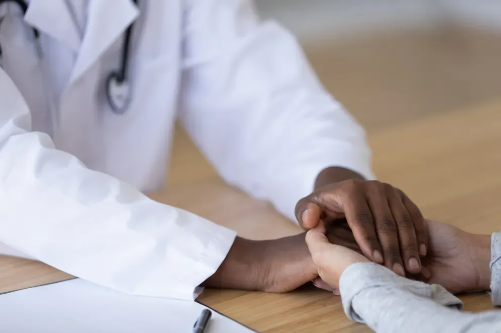 Doctor embracing a patients hand Doctor embracing a patients hand