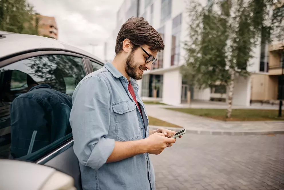 Man with phone and car Man with phone and car
