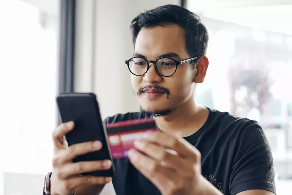 Man with phone and card Man with phone and card