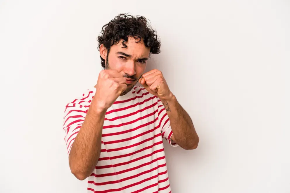 man holding up fists as to throw a punch man holding up fists as to throw a punch