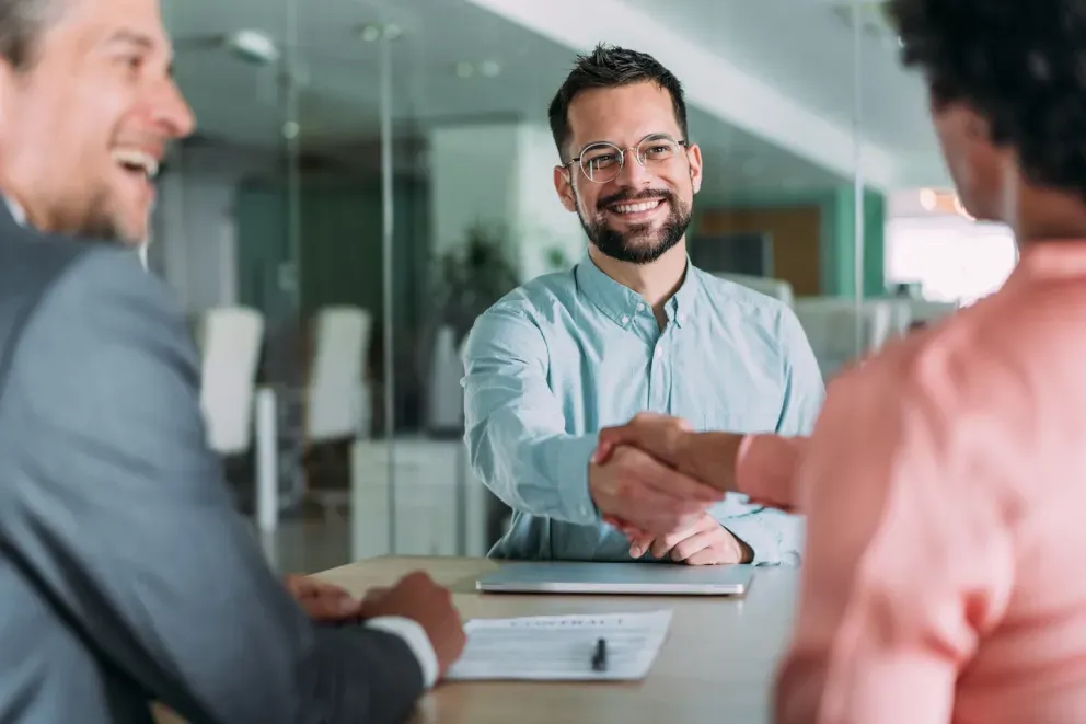smiling business man shaking clients hand smiling business man shaking clients hand