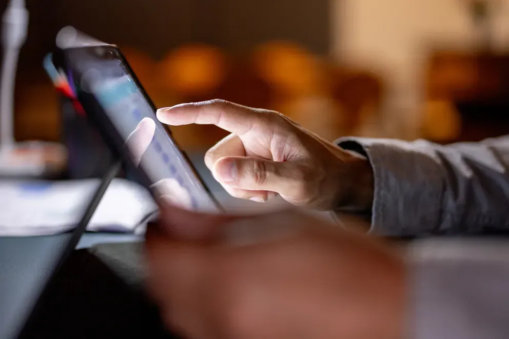 A finger tapping on a tablet screen. A finger tapping on a tablet screen.