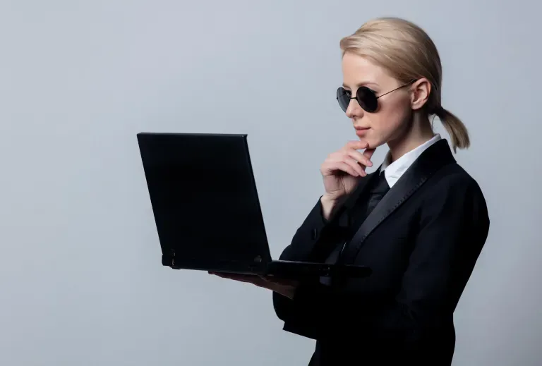 Person holding laptop with sunglasses on Person holding laptop with sunglasses on