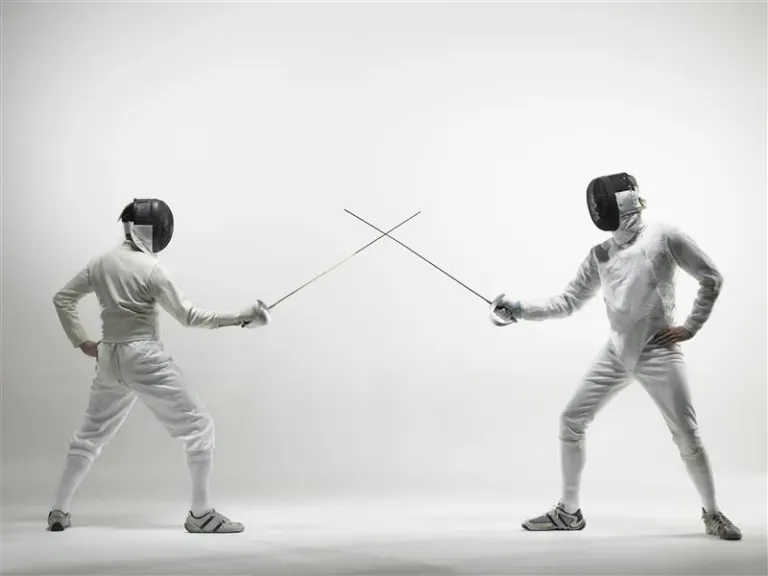 Two people fencing Two people fencing