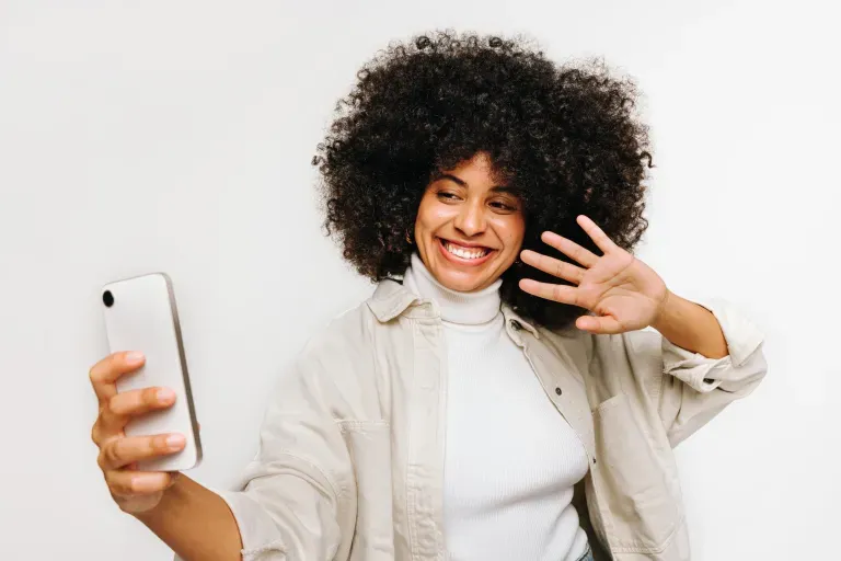 woman taking a selfie with her phone woman taking a selfie with her phone