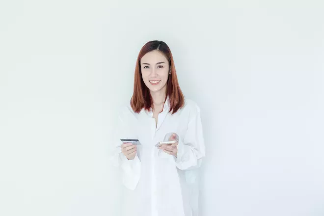 smiling woman holding cell phone and credit card smiling woman holding cell phone and credit card