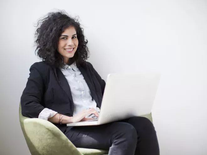 woman in chair using laptop woman in chair using laptop