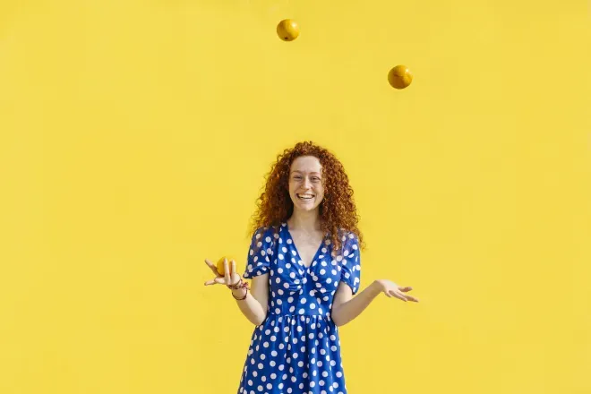 Woman juggling oranges Woman juggling oranges
