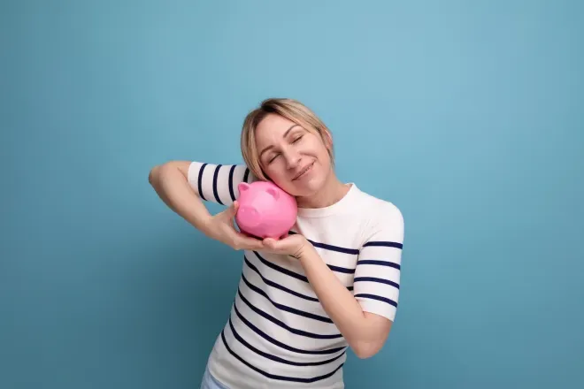 woman hugging piggy bank woman hugging piggy bank