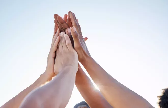 group of people giving high five group of people giving high five