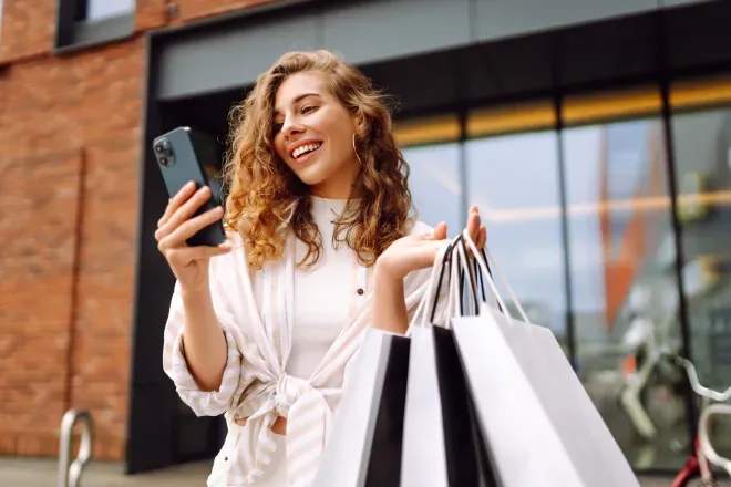 Woman with phone and shopping bags Woman with phone and shopping bags