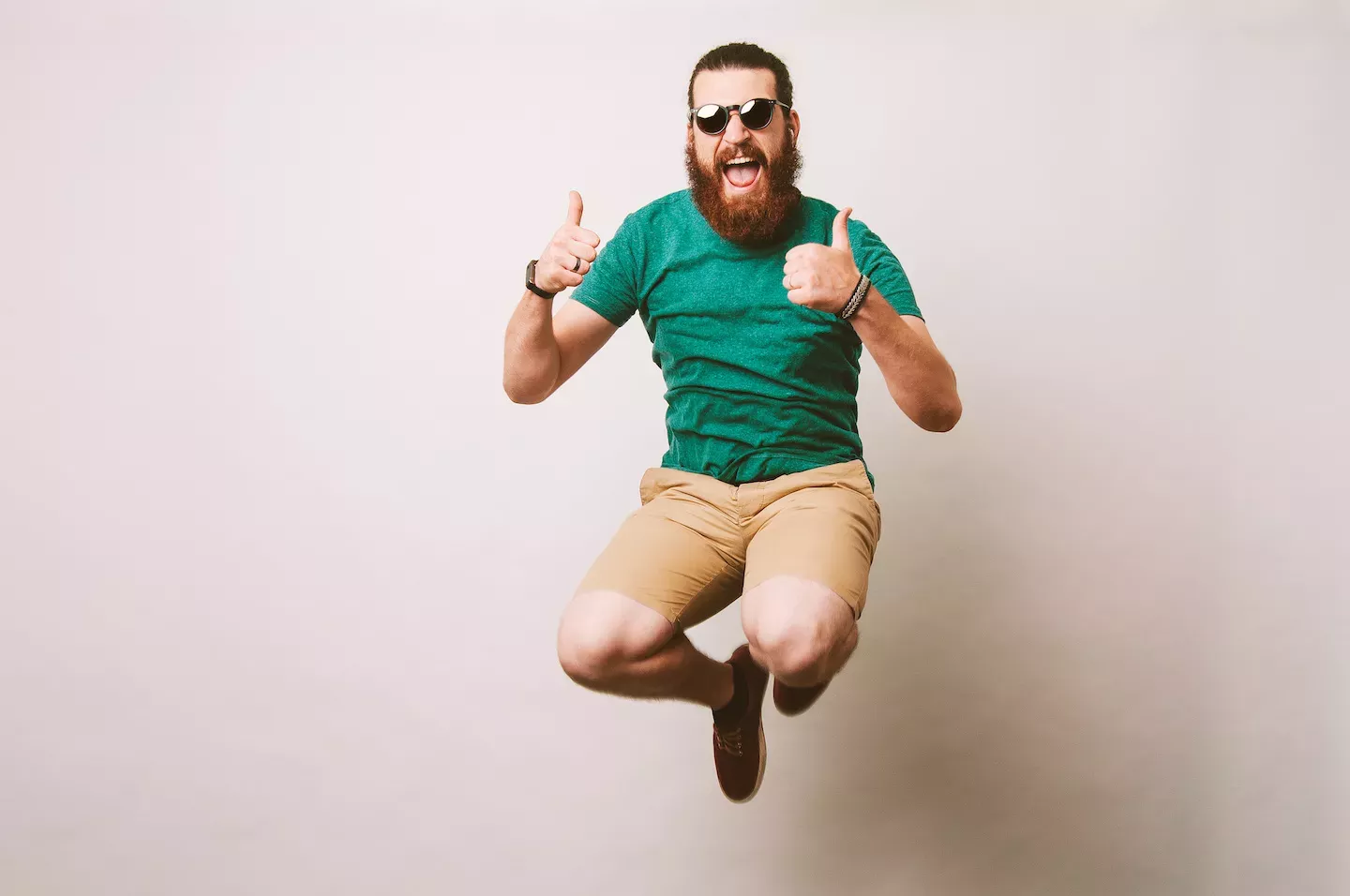 Man jumping in the air giving a thumbs up Man jumping in the air giving a thumbs up