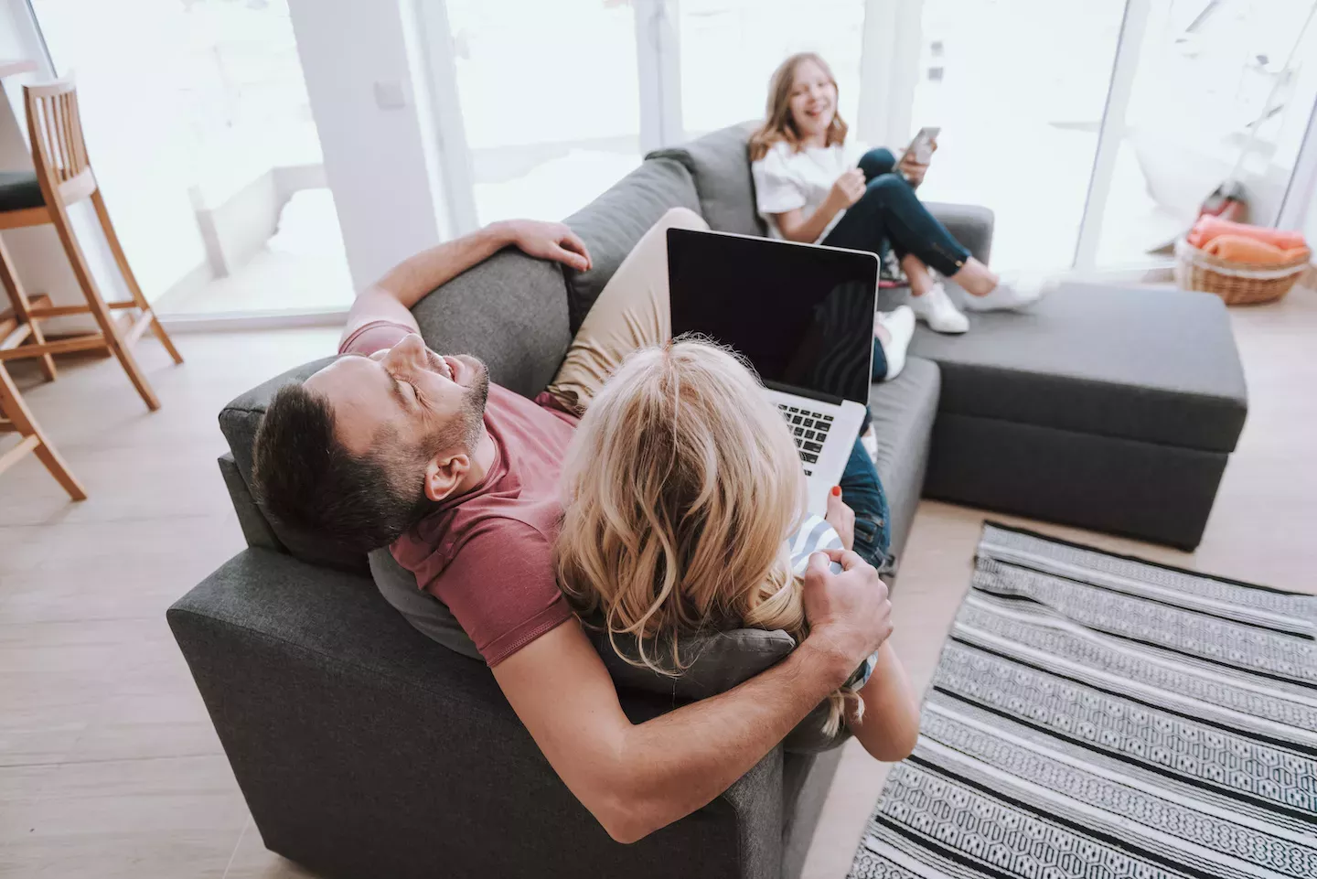 Family sitting on the couch laughing Family sitting on the couch laughing