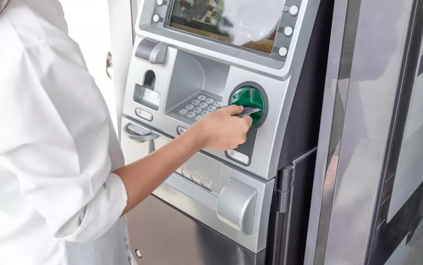 Woman using an atm machine Woman using an atm machine