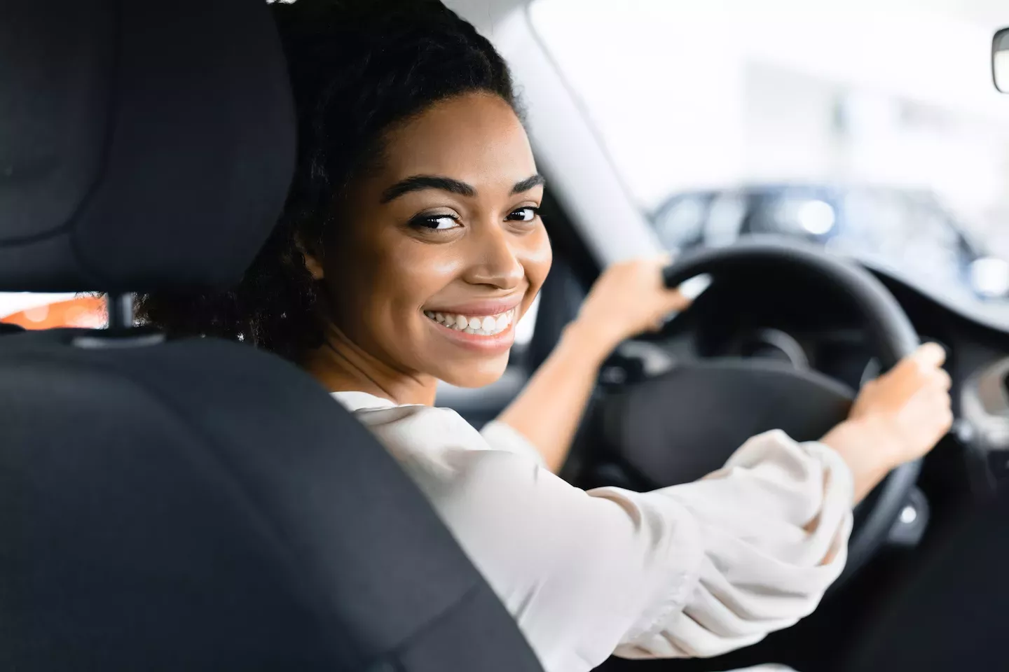 excited woman test driving a new car excited woman test driving a new car