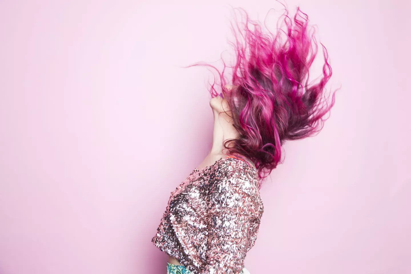 Woman with pink hair flipping it back Woman with pink hair flipping it back
