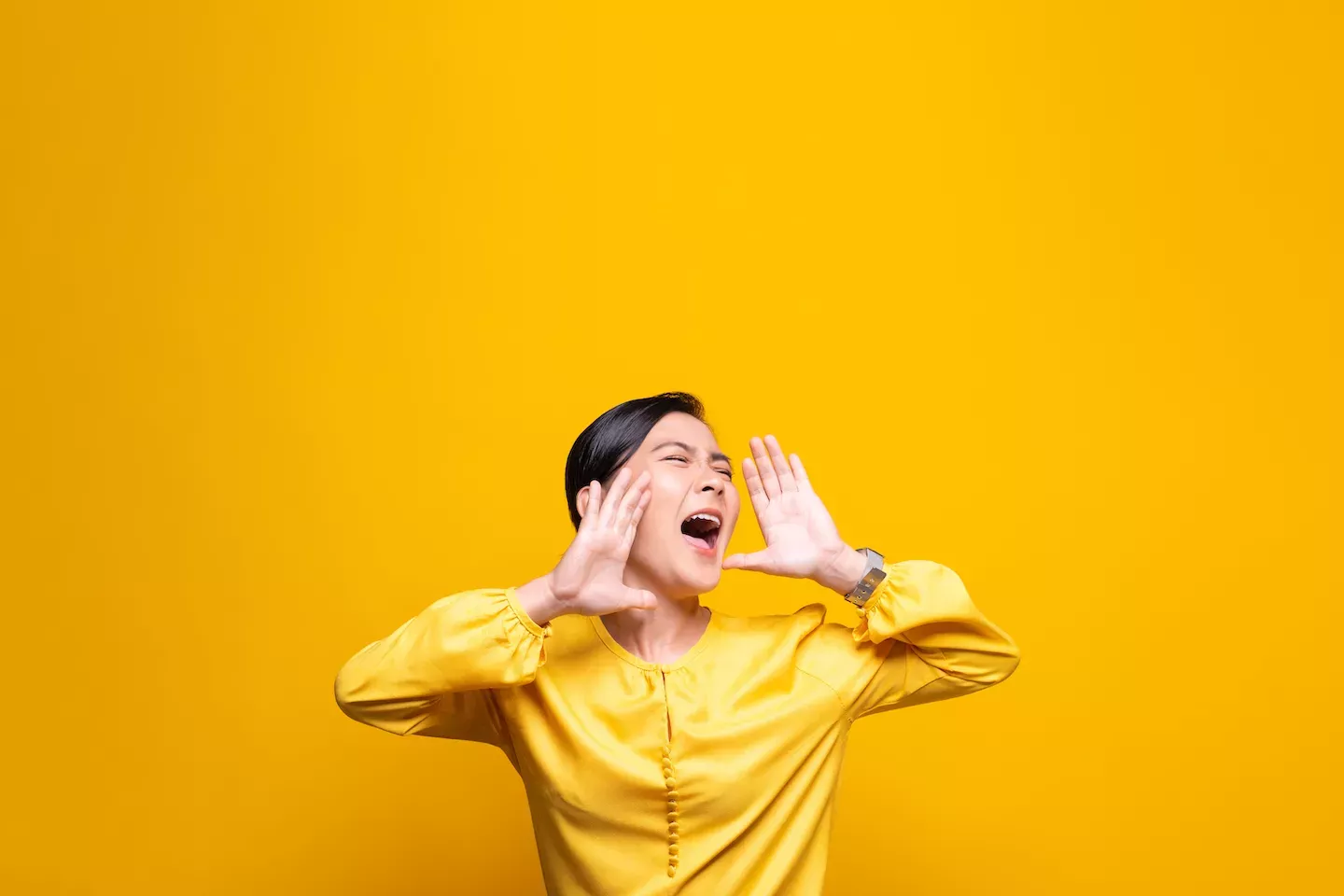 Woman shouting in a yellow shirt Woman shouting in a yellow shirt