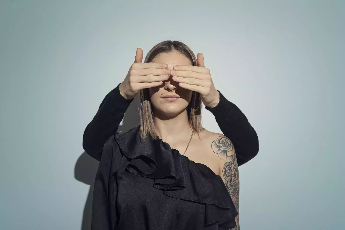 woman with hands covering her eyes woman with hands covering her eyes