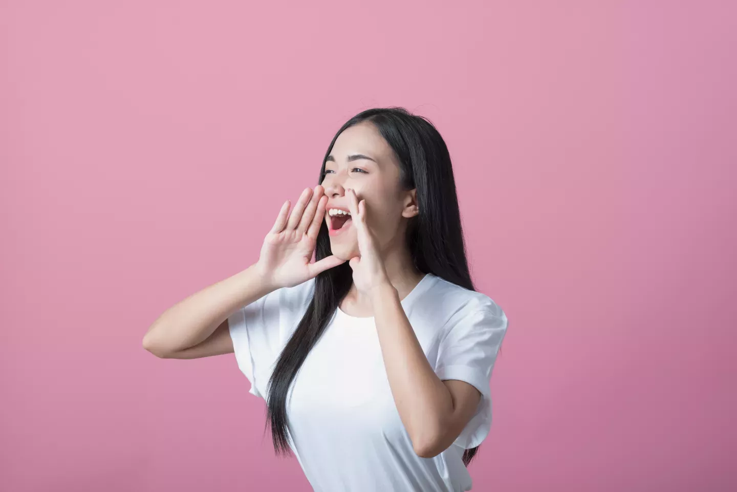 woman holding hands to mouth to shout woman holding hands to mouth to shout