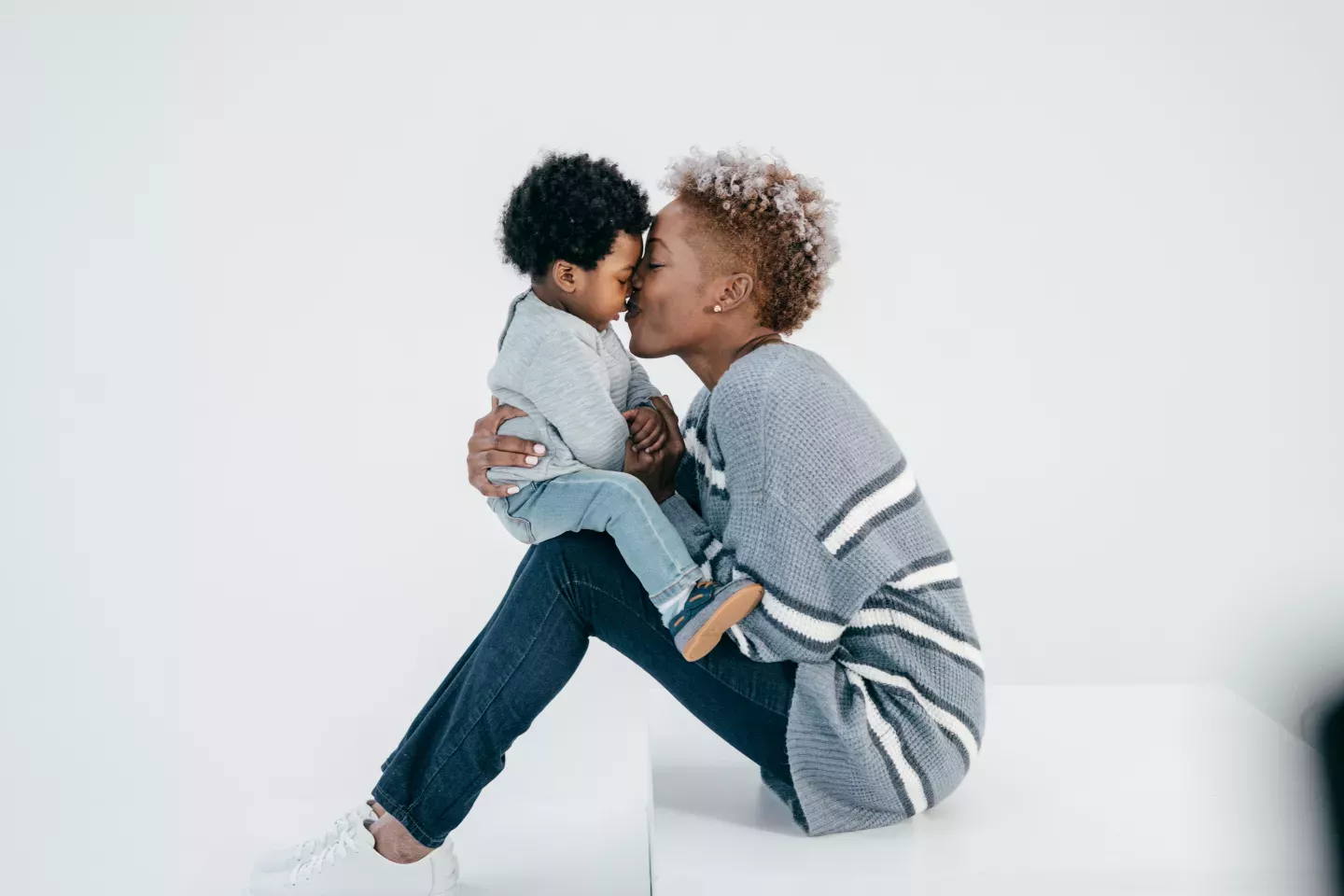 mother nuzzling young child mother nuzzling young child