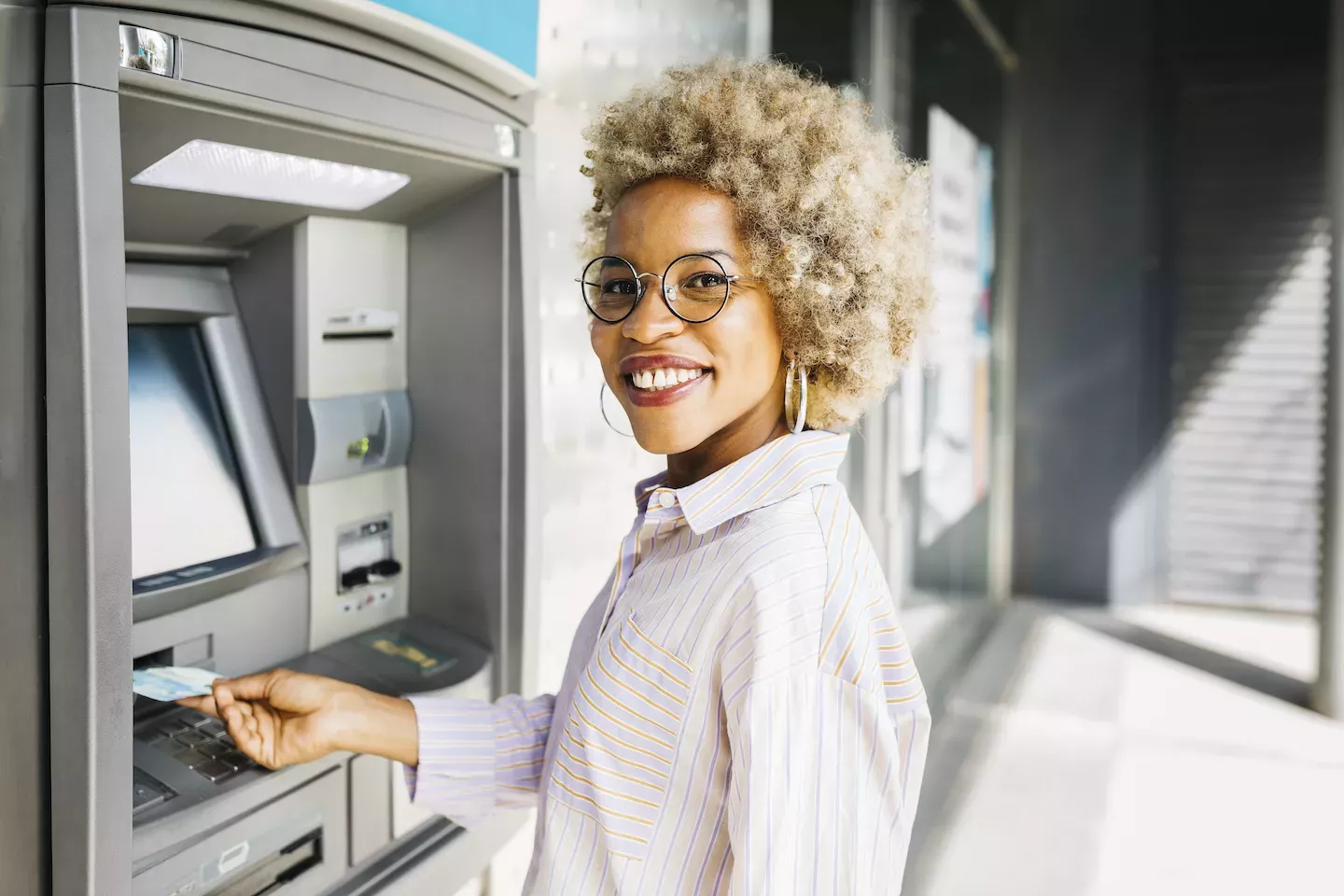 Woman using an atm machine Woman using an atm machine