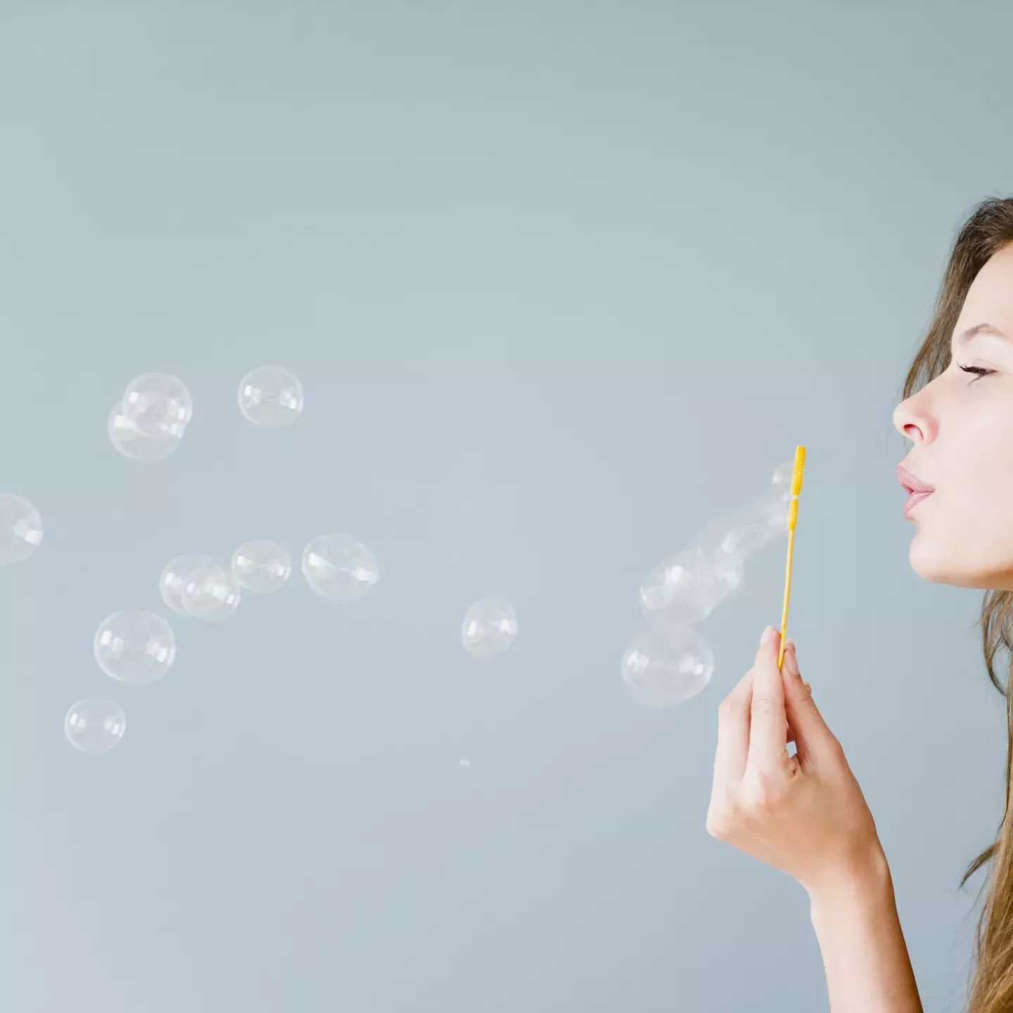 Woman blowing bubbles Woman blowing bubbles
