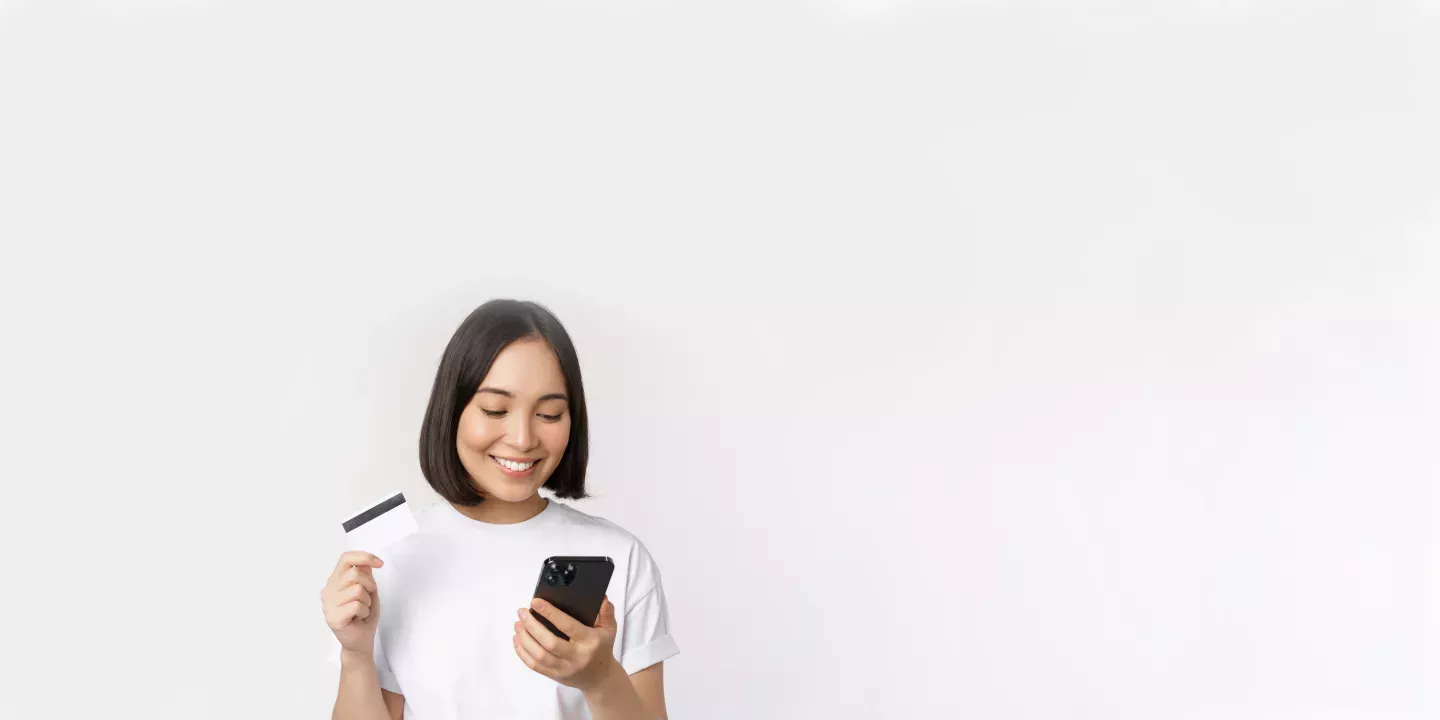 Woman holding a card and a phone Woman holding a card and a phone