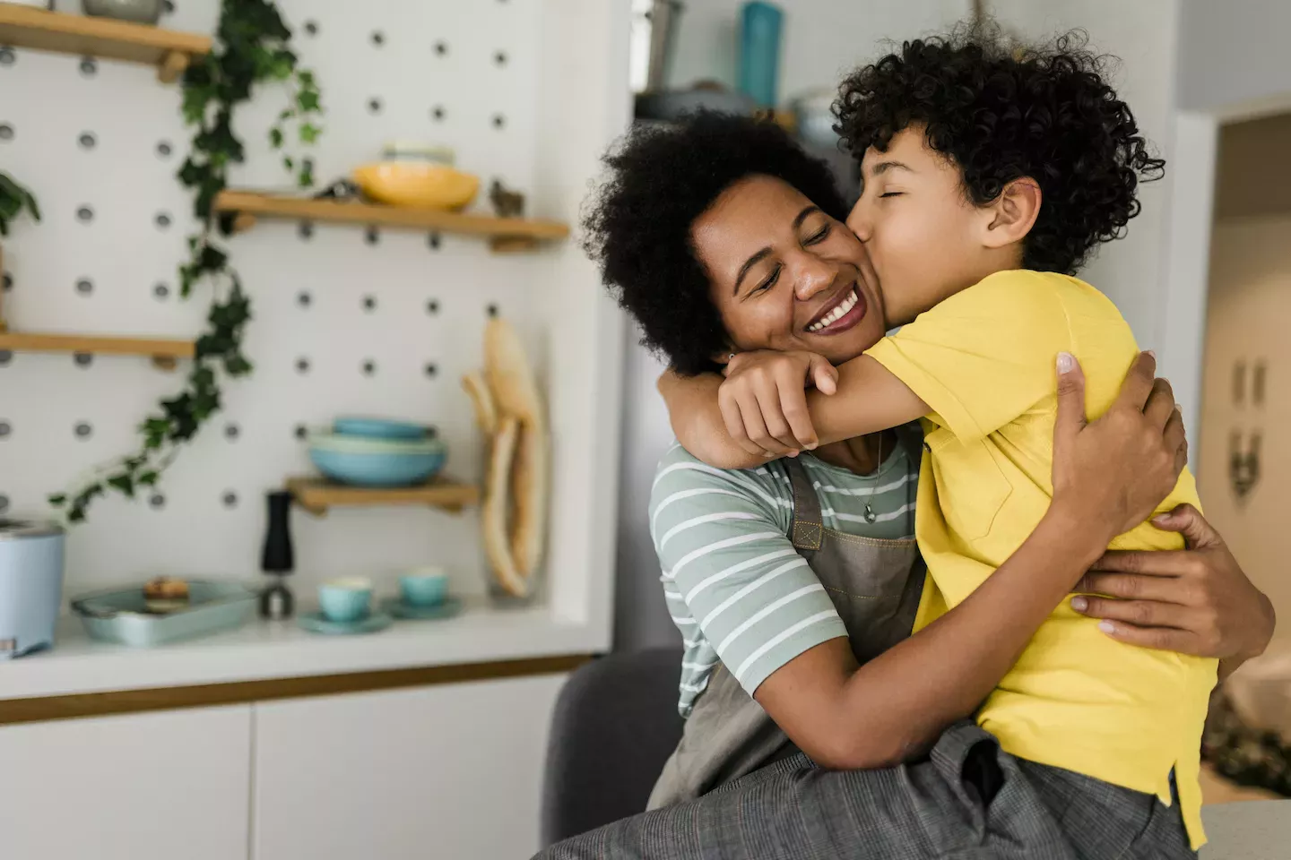 Son kissing his mother on the cheek Son kissing his mother on the cheek